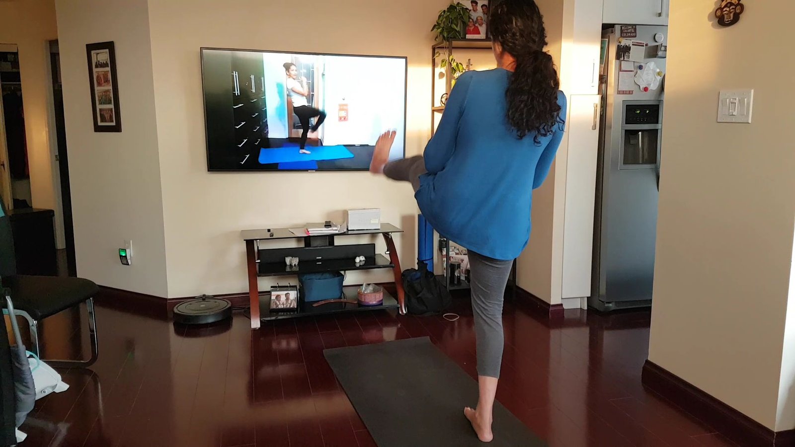 A client following along to Gaya's online fitness class on her TV